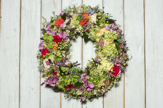 a beautiful flower wreath isolated on awooden background