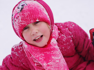 Winter portrait of a adorable 7 years old girl outdoors