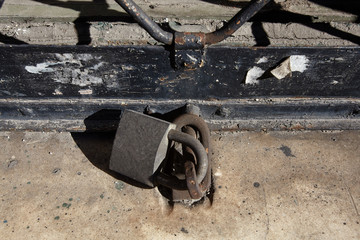 Old padlock on metal door.