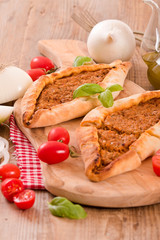 Turkish pide pizza with meat and onion. 