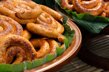 Many of Northern Thai sausages in big bowl with banana leaf ready to hot serve for dining