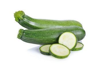 whole and sliced fresh zucchini on white background