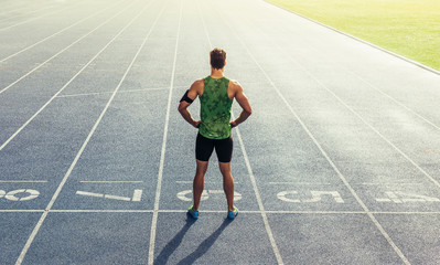 Sprinter standing on running track