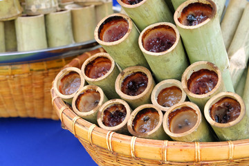 Glutinous rice roasted in bamboo joints arranged in rattan basket