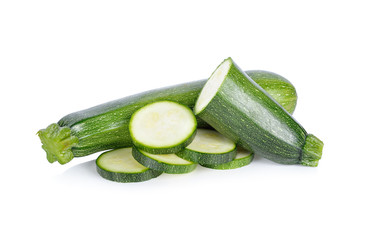 whole and sliced fresh zucchini on white background