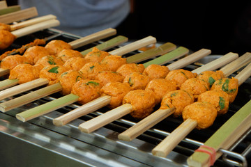 Grilled minced Clown featherback or knifefish ball with bamboo stick on the grille