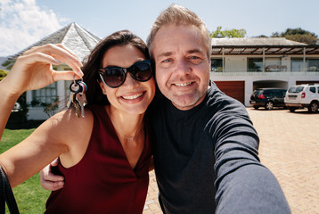Selfie of a couple with keys of new home