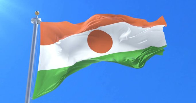Flag of Niger waving at wind in slow in blue sky, loop