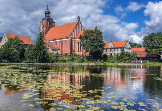 Pond on Pisa River and Saints Anne and Stephen Catholic Church in Barczewo, small city near Olsztyn, Masuria region of Poland