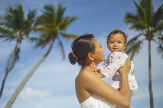 A woman with a son on a Bavaro beach in Punta Cana region of Dominican Republic