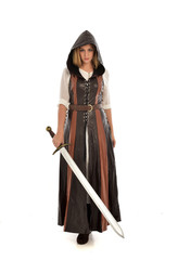 full length portrait of girl wearing brown  fantasy costume, holding a sword. standing pose on...