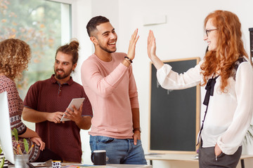 Co-workers giving a high five
