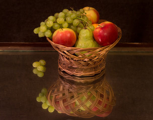 Still-life fruit basket and reflection