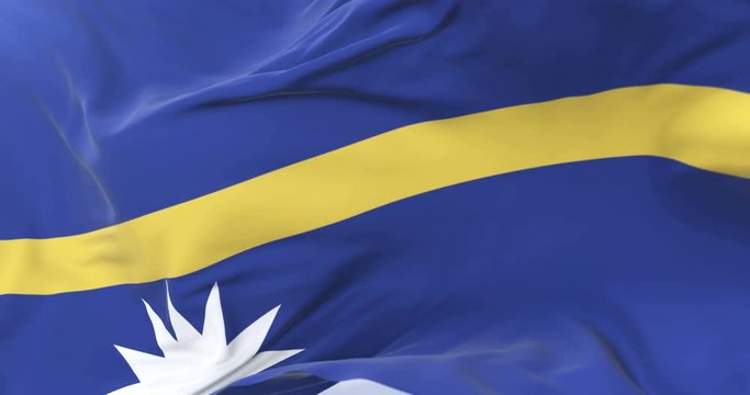 Nauru flag waving at wind in slow in blue sky, loop