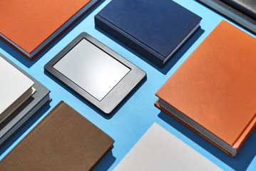 E-book and paper books on table