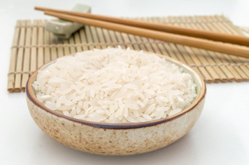 rice in a bowl and chinese chopsticks