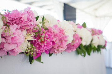 Elegant flower decoration on the table in restaurant for an event party or wedding table