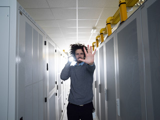 Technician shining light on server