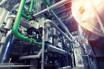 Equipment, cables and piping as found inside of a modern industrial power plant