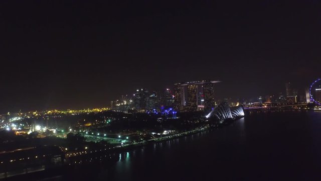 Fascinating 4k aerial drone view on big city Singapore by ocean metropolis downtown in bright night light illumination