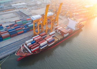 Aerial view of Containers yard in port congestion with ship vessels are loading and discharging...