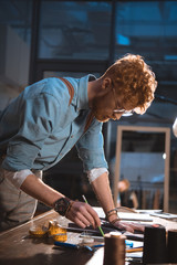 stylish young fashion designer working late in office