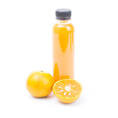 .Orange juice in plastic bottle and ripe shogun orange isolated on white background.
