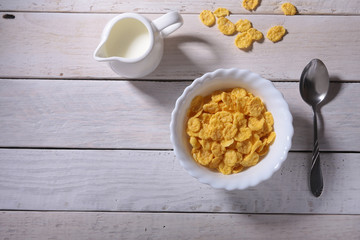 Corn Flakes cereal in a bowl and glass with milk. Morning breakfast.