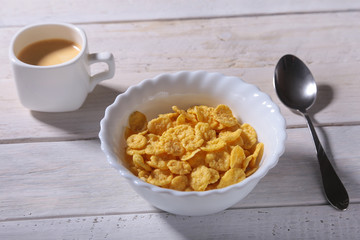Corn Flakes cereal in a bowl and cap with espresso coffee. Morning breakfast.