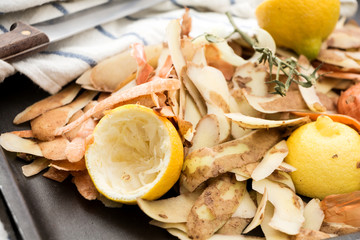 Fresh vegetable peels with knife and towel.