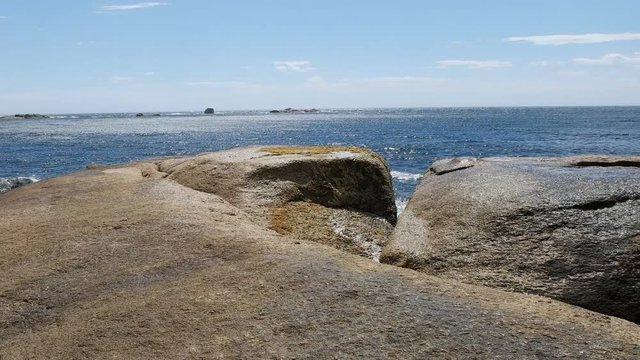 a wave breaks at the blowhole in bicheno on the east coast of tasmania, australia