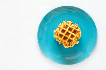Homemade Belgian waffles on blue plate. Selective focus