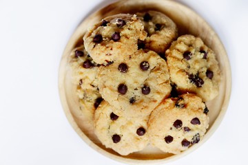 Top view, Homemade Chocolate chip cookies on the wooden dish on white background