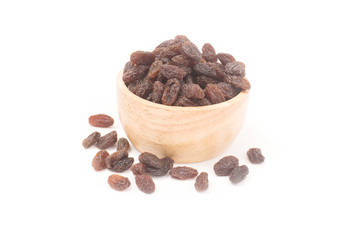 organic dried raisins in a wooden bowl isolated on white background