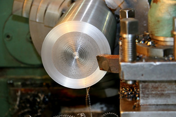 Horizontal shot of a man operating lathe grinding machine metalworking industry concept copyspace. Metal production. Cropped shot of a industry worker at his workshop operating lathe grinding machine.