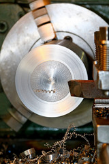 Horizontal shot of a man operating lathe grinding machine metalworking industry concept copyspace. Metal production. Cropped shot of a industry worker at his workshop operating lathe grinding machine.