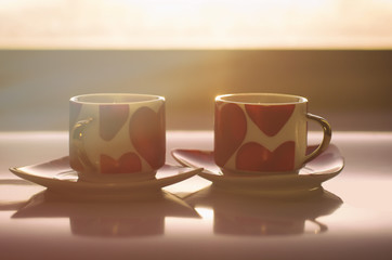 Sunny morning of Valentine's day begins with two mugs decorated with hearts