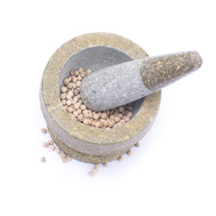 white  peppercorns in stone mortar isolated on white background