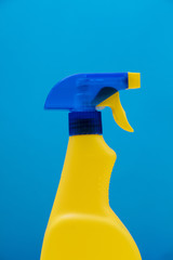 Cleaning spray bottle products on a bright blue background
