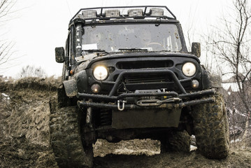 Obraz na płótnie Canvas Slip on rough terrain on reinforced serial all-wheel drive jeeps 1