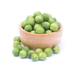 Solanum torvum or turkey berry in wooden bowl isolated on white background