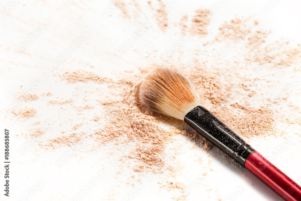 Wall mural Close-up of crushed mineral shimmer powder golden color with makeup brush