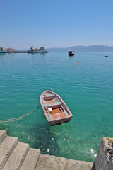Fishing boats in the blue water of Evia Island, Greece