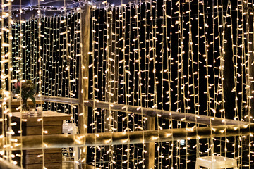 Curtains of fairy lights hanging at wedding reception