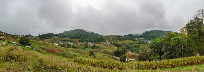 Fototapeta na wymiar Panorama view of Mon Jam valley with tourist camp and strawberry farm camp in the daytime with cloudy sky at Mae Rim, Chiang Mai Thailand.