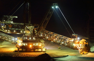 Large bucket wheel excavators in a lignite (brown-coal) mine after sunset, Germany