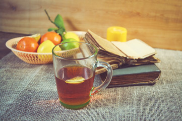 Tea with lemon and orange on wooden table
