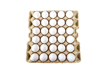 Eggs in tray of carton isolated on white background. Top view.