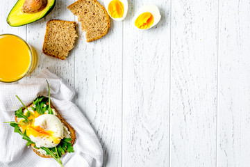 sandwich with poached eggs on wooden background top view mockup - obrazy, fototapety, plakaty