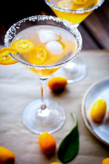 cocktail with kumquat on wooden background